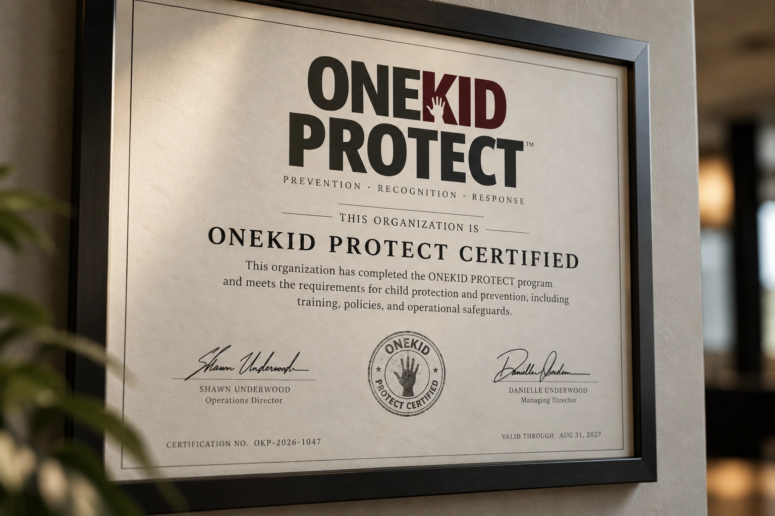 ONEKID PROTECT certification displayed in a professional environment
